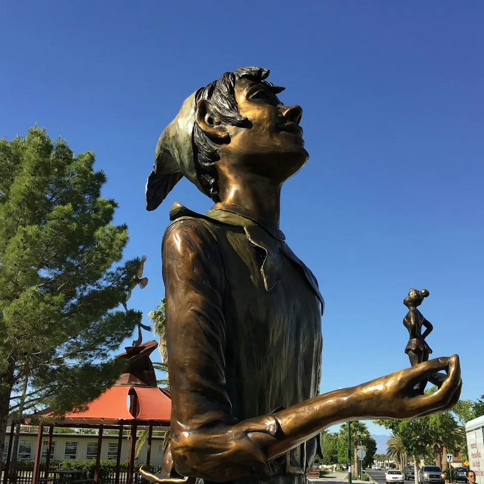 A bronze sculpture in Boulder City beneath a blue sky