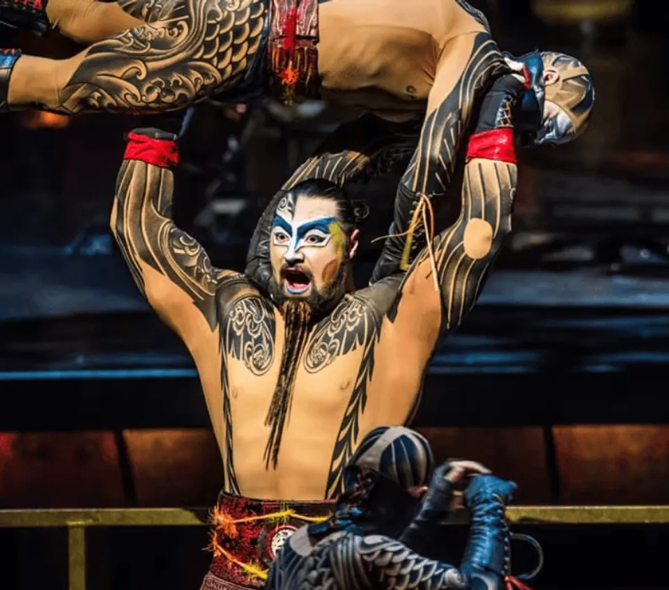 KÀ performer wearing elaborate face paint and a decorated costume