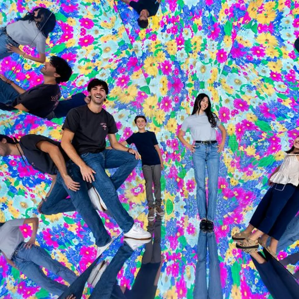 Visitors reflected among colourful patterns at Museum of Illusions