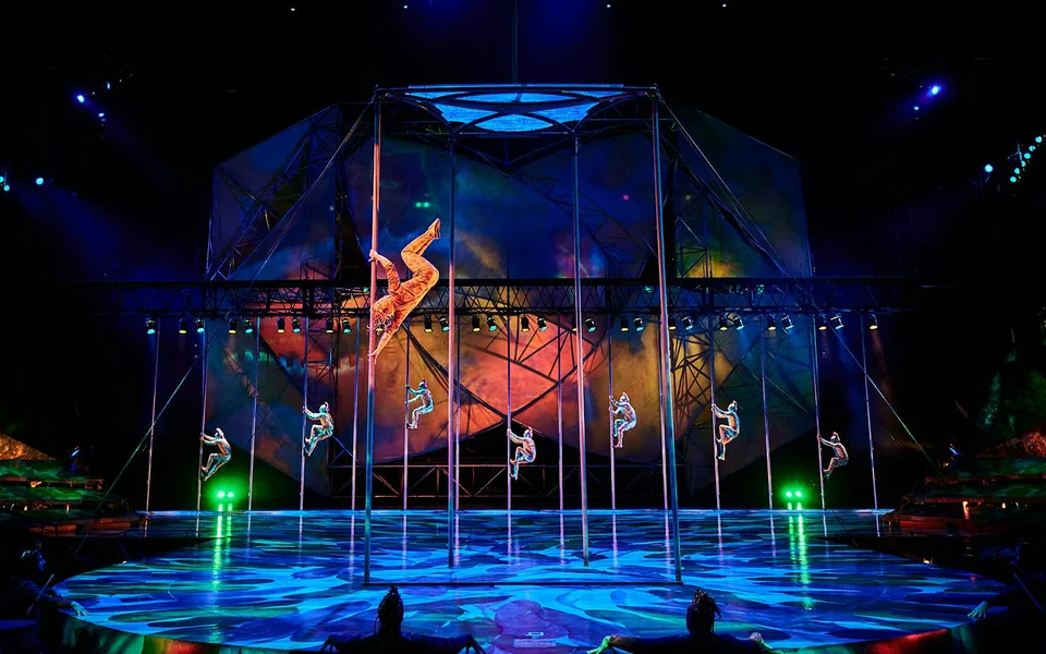 A Mystère performer inside an illuminated acrobatic structure