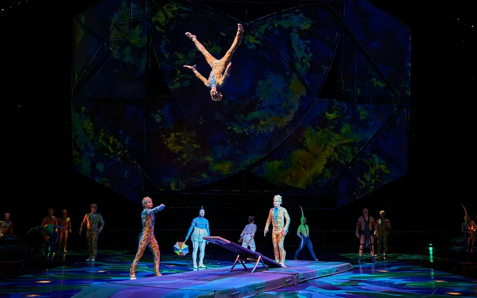 A Mystère acrobat suspended high above the ensemble