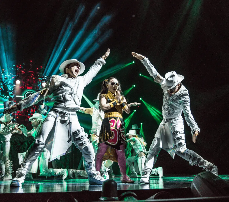 Michael Jackson ONE dancers performing together under green stage lighting