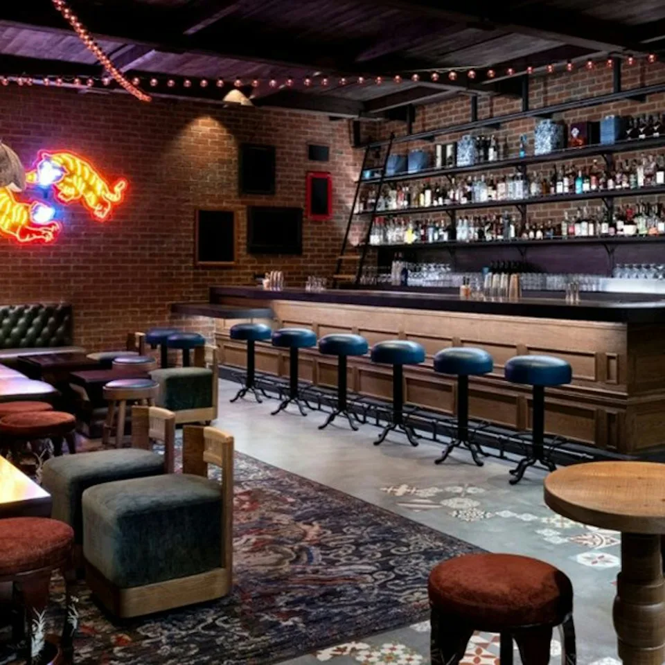 Seating and a bar inside a Resorts World lounge