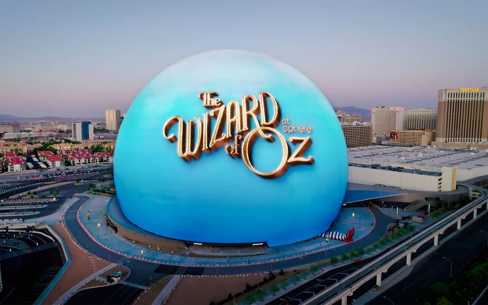 Sphere exterior displaying a blue Wizard of Oz promotion beside the Las Vegas skyline
