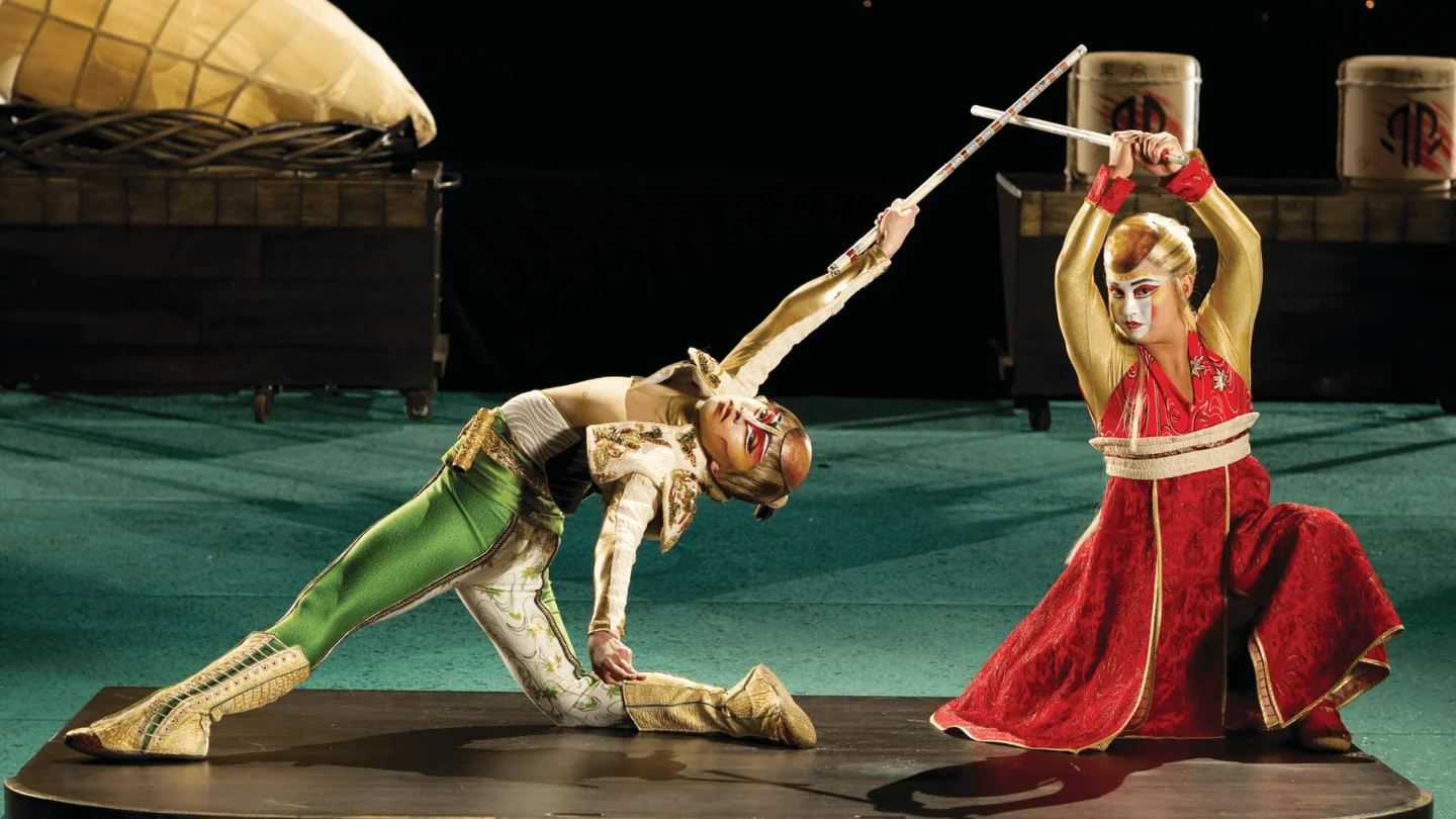 KÀ performers in costume during a staged combat sequence