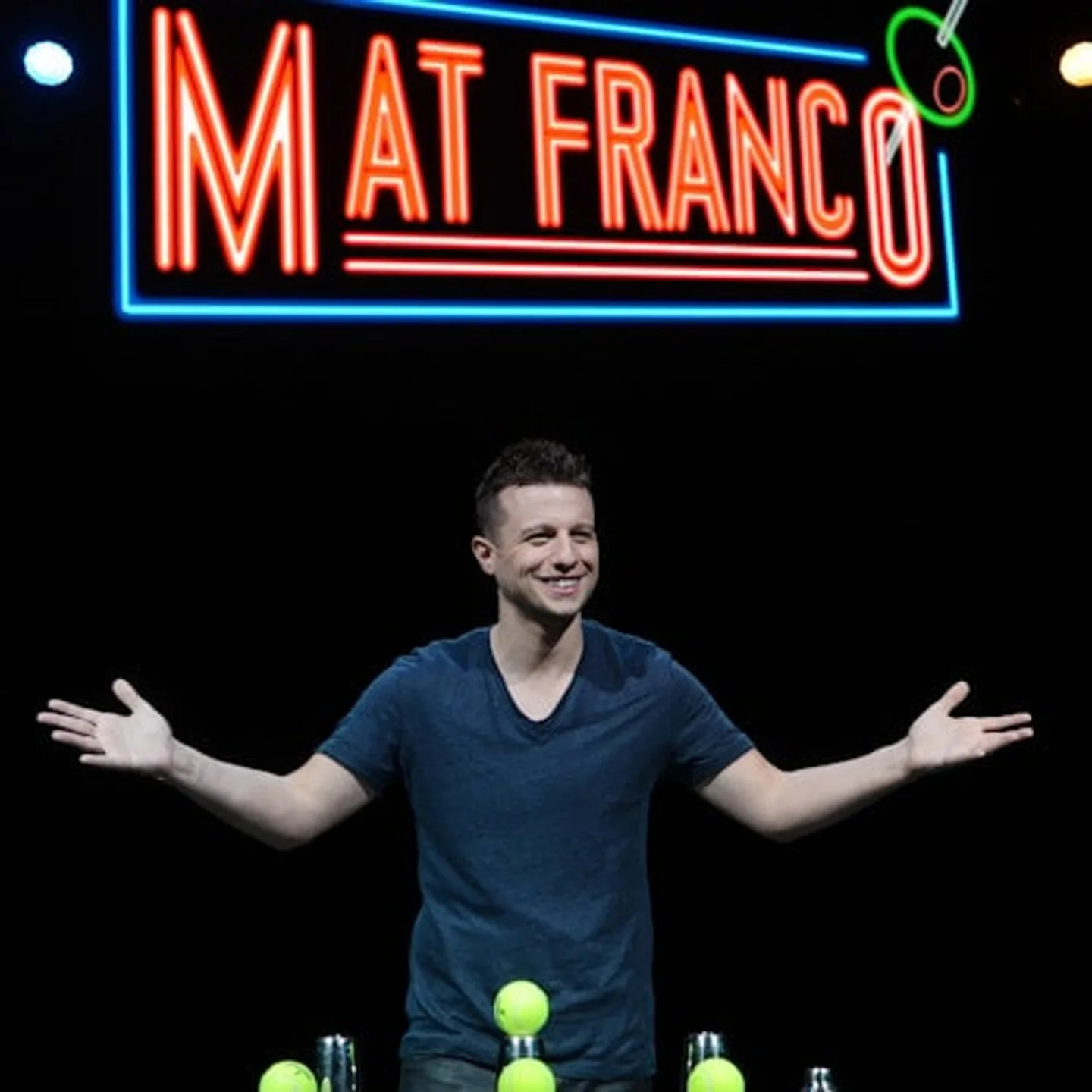 Mat Franco standing beneath an illuminated sign bearing his name