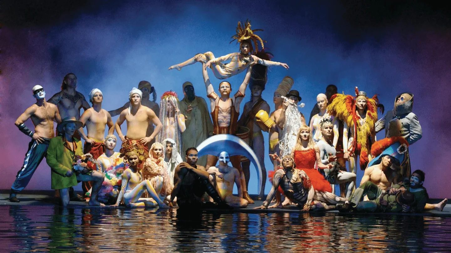 O by Cirque du Soleil ensemble posing around the water stage