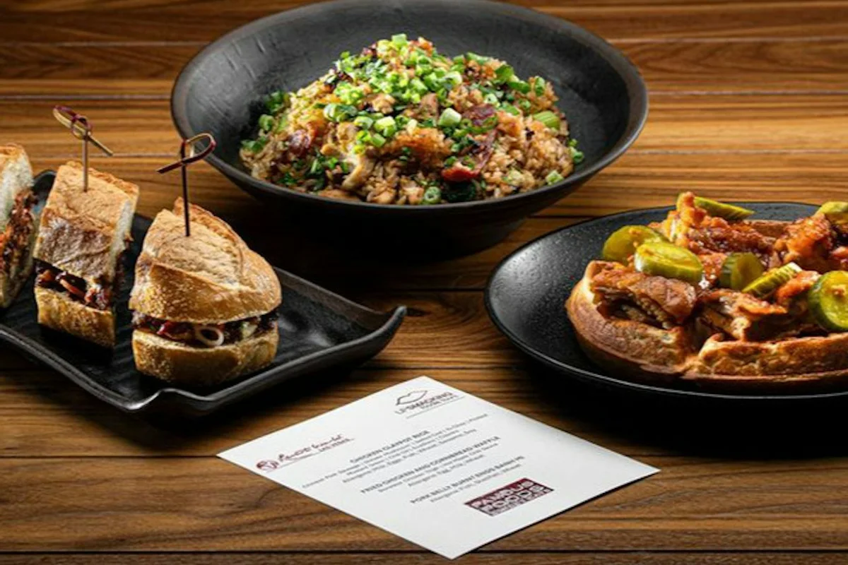 Food tasting dishes and a menu arranged on a table